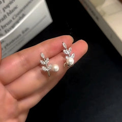 Close-up detail of the sparkling zircons and plating on the silver leaf earrings
