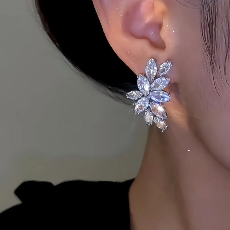 Close-up detail of the sparkling zircons and plating on the silver leaf earrings
