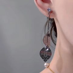 Close-up detail of the sparkling zircons and plating on the silver tassel earrings