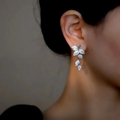 Model showcasing the dangle and style of the 14K Gold-Plated Elegant Zircon Leaf Tassel Earrings