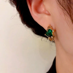 Model showcasing the dangle and style of the 14K Gold-Plated Elegant Zircon Love Heart Earrings