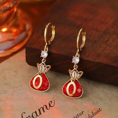 Model showcasing the dangle and style of the 14K Gold-Plated Elegant Zircon Lucky Bag Earrings