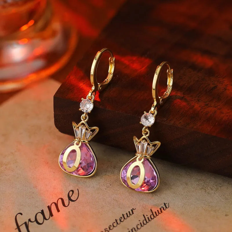 Close-up detail of the sparkling zircons and plating on the gold drop earrings