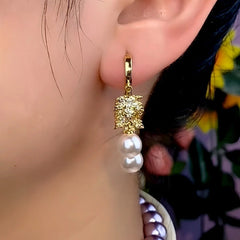 Close-up detail of the sparkling zircons and plating on the gold tassel earrings