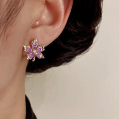Model showcasing the dangle and style of the 14K Gold-Plated Elegant Zircon Maple Leaf Stud Earrings