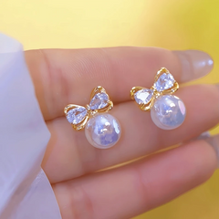 Close-up detail of the sparkling zircons and plating on the gold pearl earrings