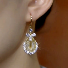 Model showcasing the dangle and style of the 14K Gold-Plated Elegant Zircon Mesh Water Drop Earrings