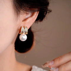 Model showcasing the dangle and style of the 14K Gold-Plated Elegant Zircon Multi-Layer Pearl Earrings