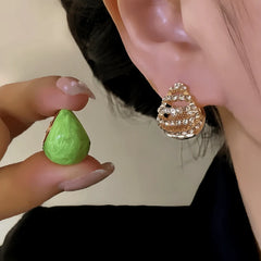 Close-up detail of the sparkling zircons and plating on the green drop earrings