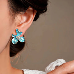 Close-up detail of the sparkling zircons and plating on the blue flower earrings