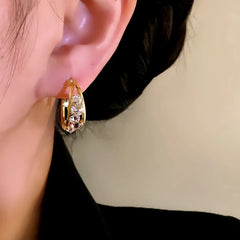 Model showcasing the dangle and style of the 14K Gold-Plated Elegant Zircon Oval Hoop Earrings