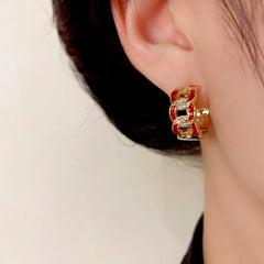 Model showcasing the dangle and style of the 14K Gold-Plated Elegant Zircon Paint Chain Hoop Earrings