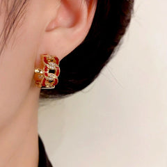 Close-up detail of the sparkling zircons and plating on the gold hoop earrings