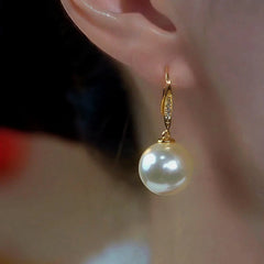 Model showcasing the dangle and style of the 14K Gold-Plated Elegant Zircon Pearl Ear Hooks