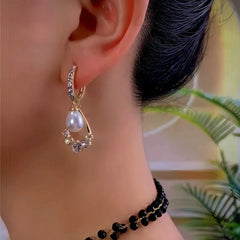 Model showcasing the dangle and style of the 14K Gold-Plated Elegant Zircon Pearl Earrings