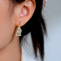 Close-up detail of the sparkling zircons and plating on the gold pearl earrings