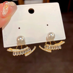 Close-up detail of the sparkling zircons and plating on the gold jacket earrings