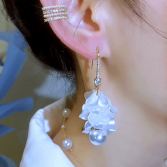 Close-up detail of the sparkling zircons and plating on the gold tassel earrings