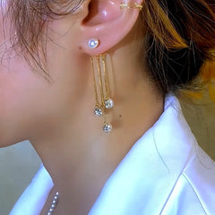 Close-up detail of the sparkling zircons and plating on the gold pearl earrings