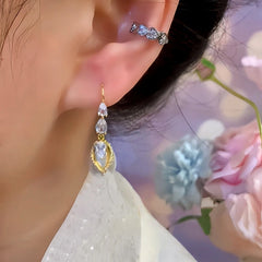 Close-up detail of the sparkling zircons and plating on the gold pearl earrings