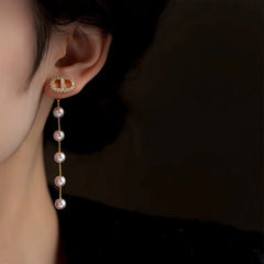 Close-up detail of the sparkling zircons and plating on the Pig Nose Pearl Earrings