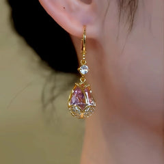 Model showcasing the dangle and style of the 14K Gold-Plated Elegant Zircon Pink Diamond Tulip Earrings