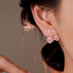 Model showcasing the dangle and style of the 14K Gold-Plated Elegant Zircon Pink Flower's Stud Earrings