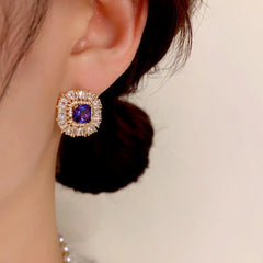 Model showcasing the dangle and style of the 14K Gold-Plated Elegant Zircon Purple Diamond Stud Earrings