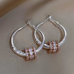 Model showcasing the dangle and style of the 14K Gold-Plated Elegant Zircon Ring Hoop Earrings