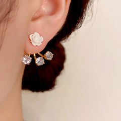 Model showcasing the dangle and style of the 14K Gold-Plated Elegant Zircon Rose Jacket Earrings