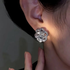 Model showcasing the dangle and style of the 14K Gold-Plated Elegant Zircon Rose Stud Earrings
