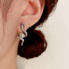 Model showcasing the dangle and style of the 14K Gold-Plated Elegant Zircon Snake-Shaped Pearl Earrings