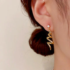 Model showcasing the dangle and style of the 14K Gold-Plated Elegant Zircon Snake-Shaped Spiral Earrings