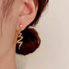Close-up detail of the sparkling zircons and plating on the Spiral Snake Earrings