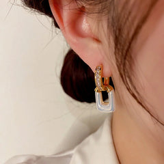 Close-up detail of the sparkling zircons and plating on the Square Hoop Earrings