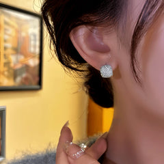 Close-up detail of the sparkling zircons and plating on the Square Hoop Earrings