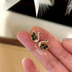 Model showcasing the dangle and style of the 14K Gold-Plated Elegant Zircon Swan Stud Earrings