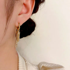 Model showcasing the dangle and style of the 14K Gold-Plated Elegant Zircon Tassel Earrings