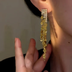 Model showcasing the dangle and style of the 14K Gold-Plated Elegant Zircon Tassel Earrings