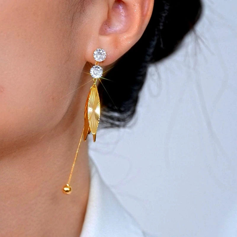 Model showcasing the dangle and style of the 14K Gold-Plated Elegant Zircon Tassel Earrings