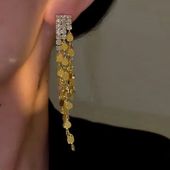 Close-up detail of the sparkling zircons and plating on the Gold Tassel Earrings