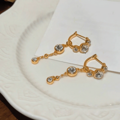 Angled view of the 14K Gold-Plated Elegant Zircon Tassel Earrings