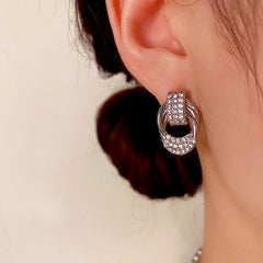 Model showcasing the dangle and style of the 14K Gold-Plated Elegant Zircon Twisted Earrings
