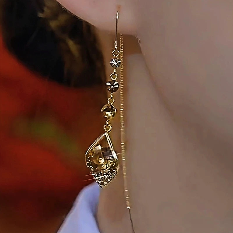 Model showcasing the dangle and style of the 14K Gold-Plated Elegant Zircon Water Drop Earrings