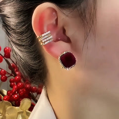 Close-up detail of the sparkling zircons and plating on the Wine Red Stud Earrings