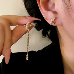 Close-up detail of the sparkling zircons and plating on the Cross Tassel Earrings