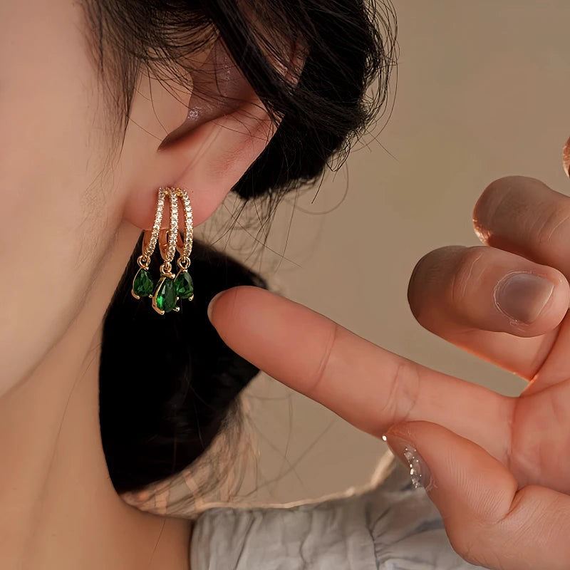 Model showcasing the dangle and style of the 14K Gold-Plated Elegant Green Zircon Diamond Tassel Earrings