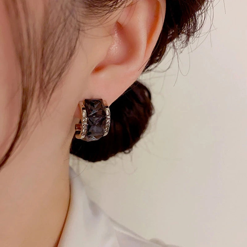 Model showcasing the dangle and style of the 14K Gold-Plated Exquisite Black Square Diamond Earrings