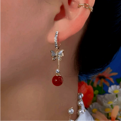Close-up detail of the sparkling zircons and plating on the Butterfly Red Bead Earrings