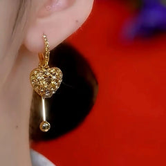 Close-up detail of the sparkling zircons and plating on the Crystal Heart Tassel Earrings